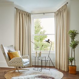 boheme hemp floor length curtains in bay window in cosy bedroom