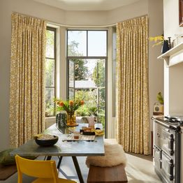 wirl chartreuse patterned floor length curtains on patio doors in dining room