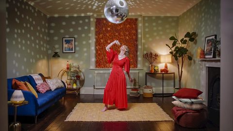 Nora bruschetta motorised roman blinds in living room with woman dancing under disco ball