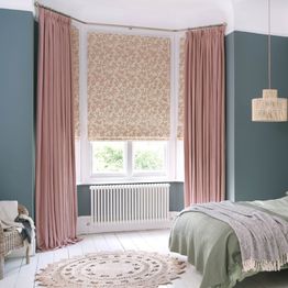 bailey taffy curtains paired with delizia blush roman blinds in cosy bedroom