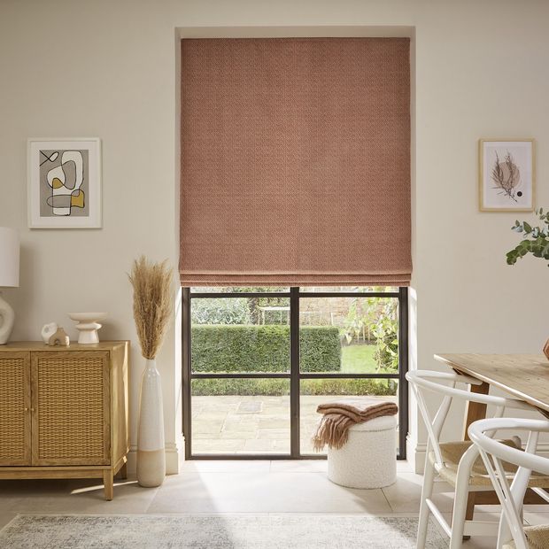 Wave blush roman blinds on crittal window in living room