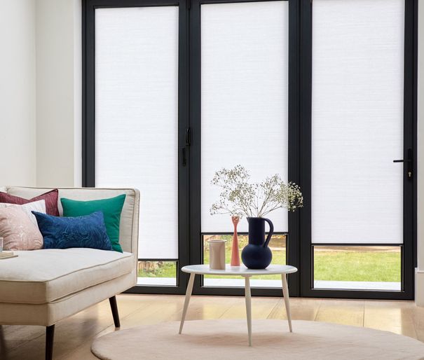 white microhive intu pleated blinds on bifold doors in living room