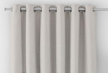off white curtain header with silver eyelets on a silver curtain pole