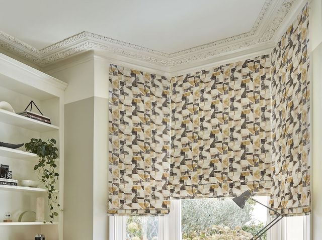 fraction amber gold roman blinds in bay window