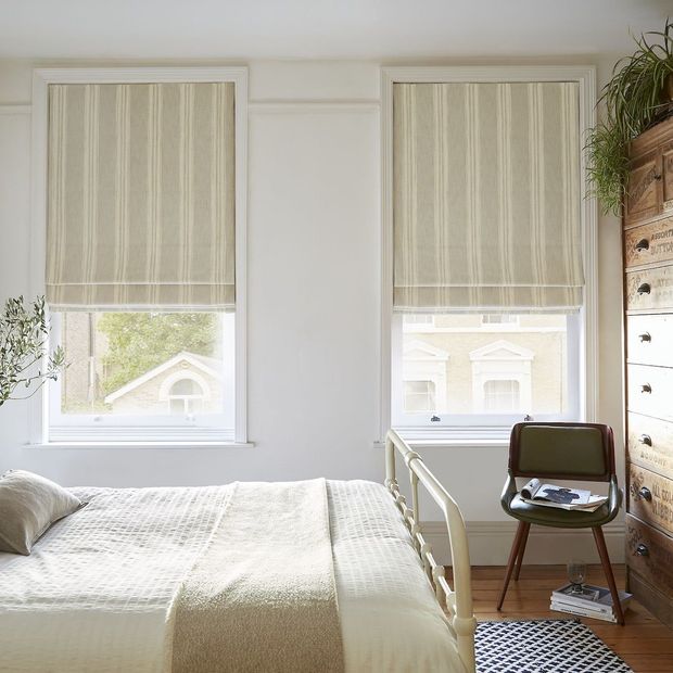 pair of duke olive roman blinds in cream themed bedroom