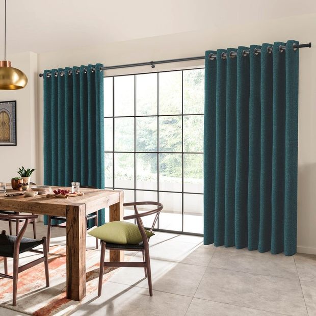 boheme teal floor length eyelet curtains in dining room with wooden table and chairs