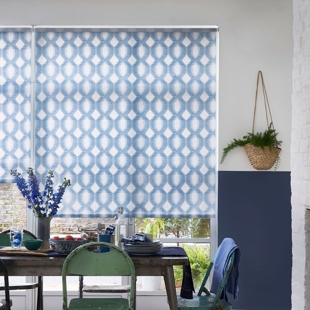 Brindle denim roller blinds on large window in green and blue spring themed living room