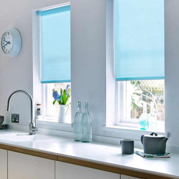 Pair of acacia azure roller blinds in small window above sink in kitchen