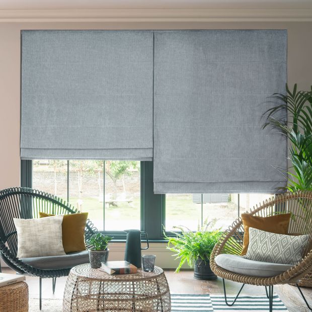 Pair of kendra navy roller blinds in wicker and green living space