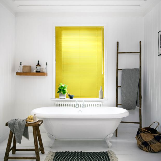 Buttercup yellow metal venetian in bathroom above bathtub