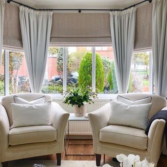 Maisie almond roman blinds in bay window in contemporary living room