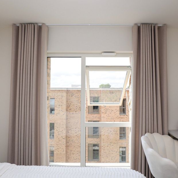 pink plain floor length curtains in minimalist bedroom