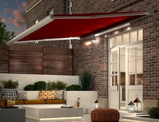 verona rouge awning with lights and heaters covering patio at night 