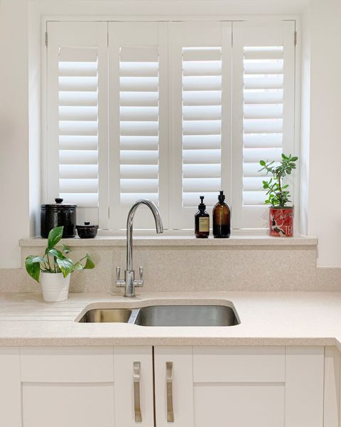 pure white full height shutters on small window in kitchen above sink