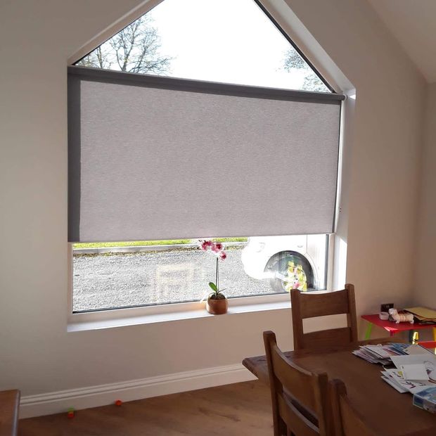 conscious mink roller blind on usually angled window in dining room