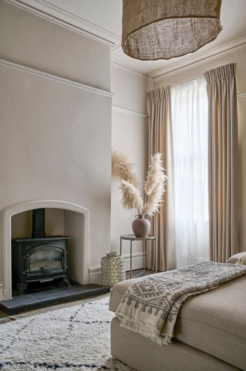 Floor length lindora linen curtains paired with astro cream voile curtains in cosy beige bedroom