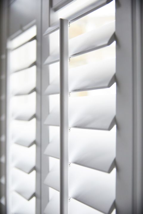 detail of pure white wooden shutter louvres