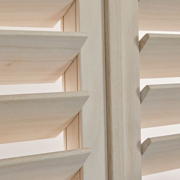 close up of open matte white wood grain shutters