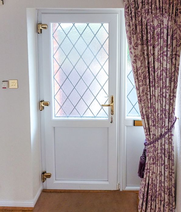 floor length delizia violet floral patterned curtains tied back over front door
