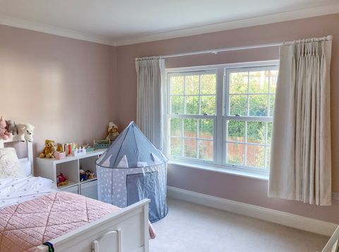 cream short length curtains on large window in childrens bedroom