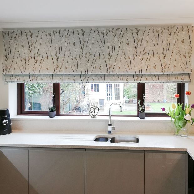 beige floral roman blind on long window in kitchen above sink