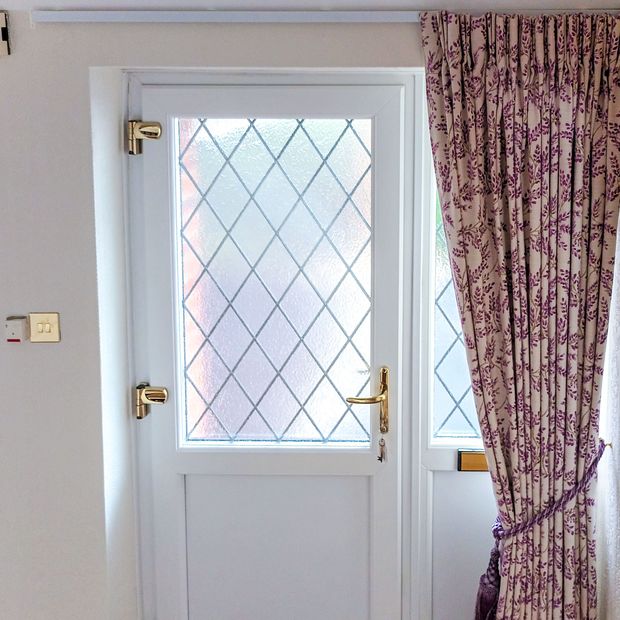 delizia violet floral patterned floor length curtains tied back in front of front door