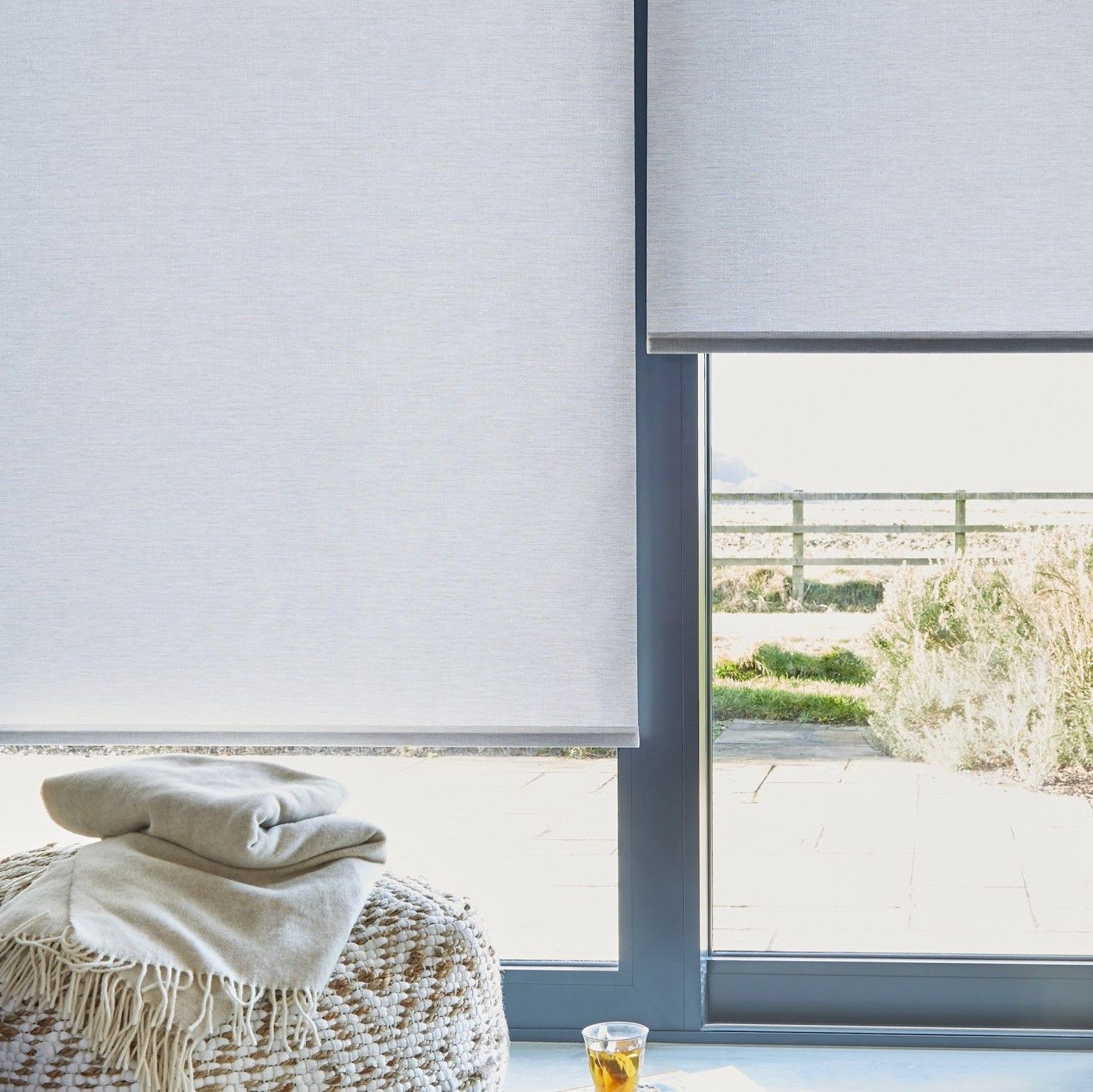 close up of light grey sustainable roller blinds on sliding patio doors