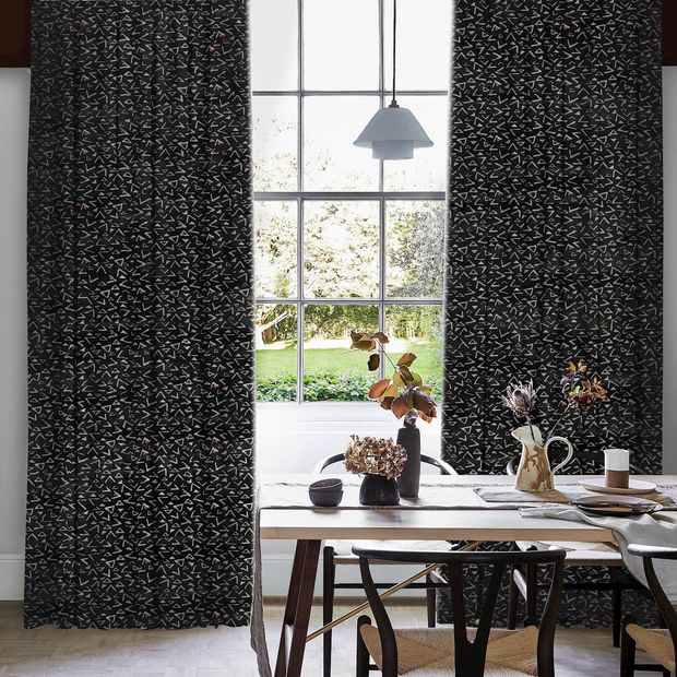 black and white patterned floor length curtains in dining room