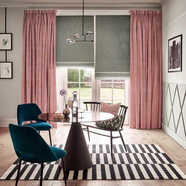 pinch pleat dusty pink patterned curtains paired with grey roman blinds on french doors in dining room