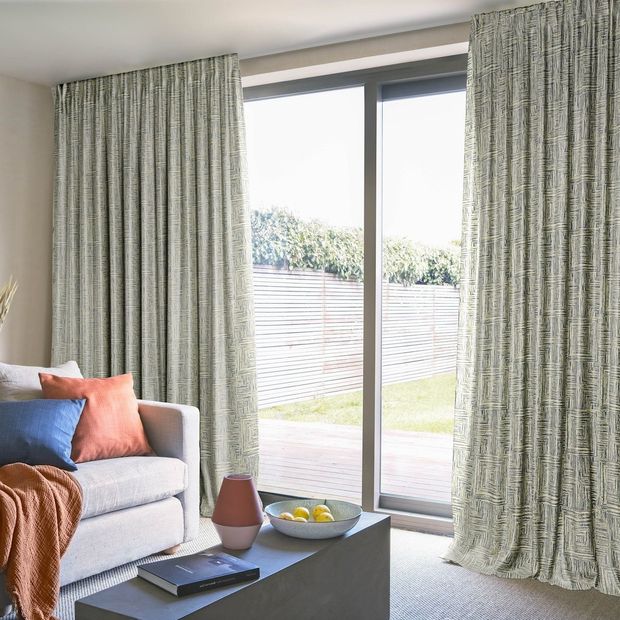 grey geometric patterned floor length curtains on sliding patio doors in living room
