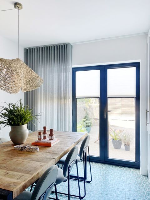light grey voiles paired with white pleated blinds on patio doors in dining room