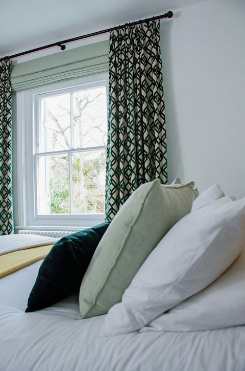 kendra sage roman blinds paired with loxly emerald patterned curtains in teenagers bedroom