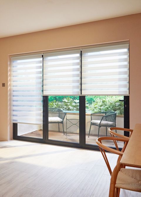 white day and night blinds on patio doors in dining and kitchen area
