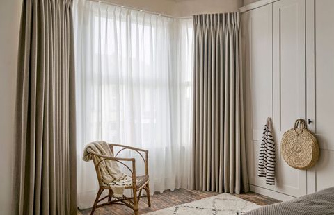 Lindora linen floor length curtains paired with cream voiles in cosy bedroom