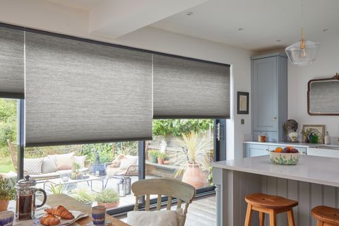 Electric grey pleated honeycomb blinds on large sliding patio doors in kitchen