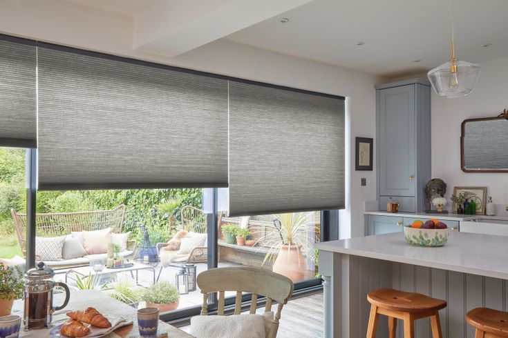 Electric grey pleated honeycomb blinds on large sliding patio doors in kitchen
