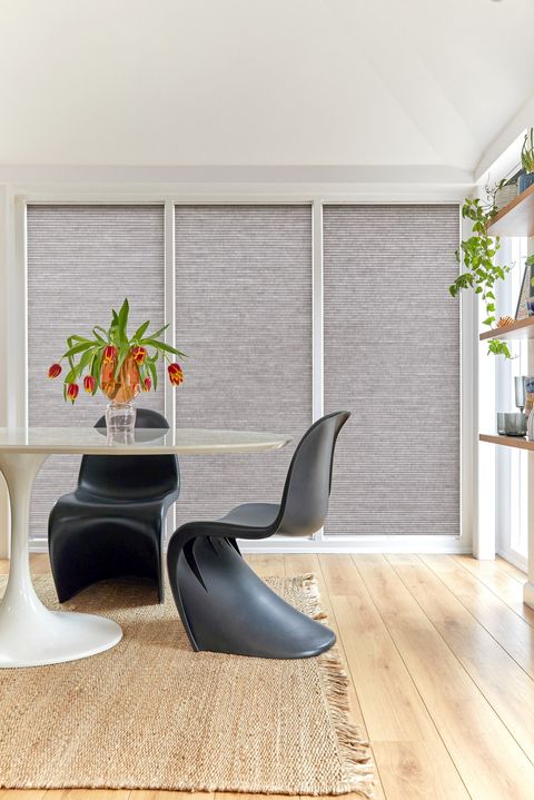 fully closed grey duette pleated blinds on large windows in open dining space