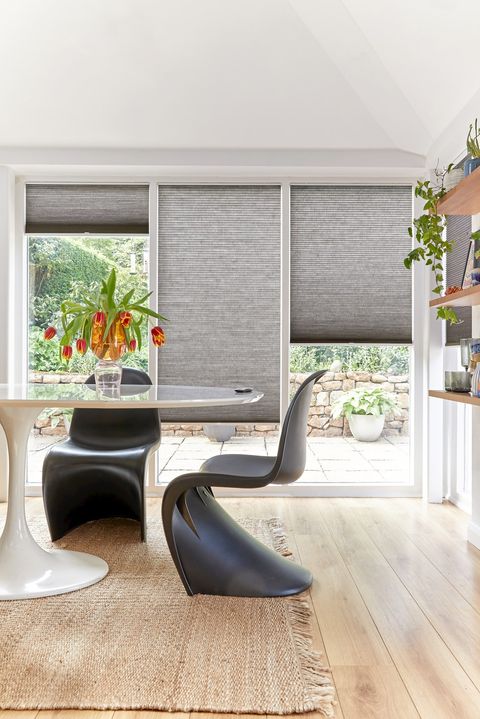  grey duette pleated blinds on large windows in open dining space