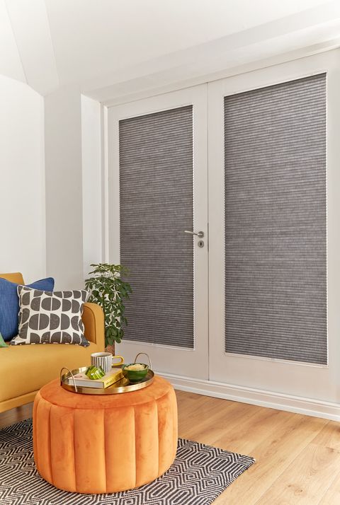  grey duette pleated blinds on large windows in open dining space
