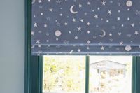 Close up of starred navy blue roman blind in childrens bedroom