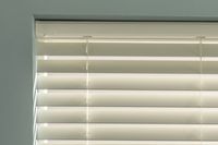 ivory coloured wooden blinds with colour coordinated head rail