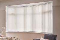 pink vertical blinds on curved bay window in bedroom