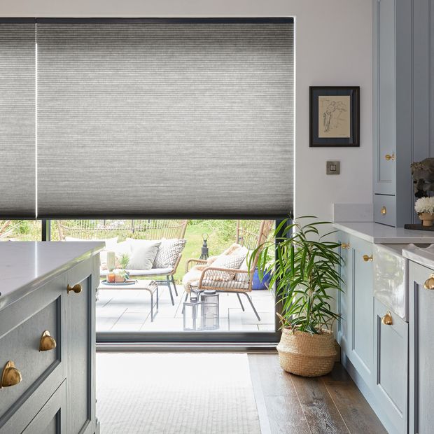 grey duette pleated blinds on french doors and large windows in modern dining area