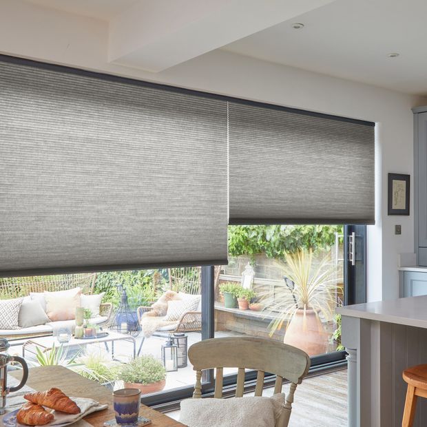 grey duette pleated blinds on large windows in open dining space
