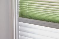 close up of green and white transition blinds paired together on window