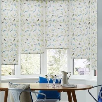 Floral patterned Joya Yellow roller blinds hung in dining room