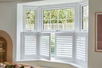 cafe style shutters on bay window in dining room