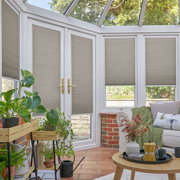 grey duette pleated blinds on windows in circular conservatory