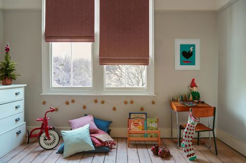 pair of red roman blinds on windows in christmas themed childs bedroom