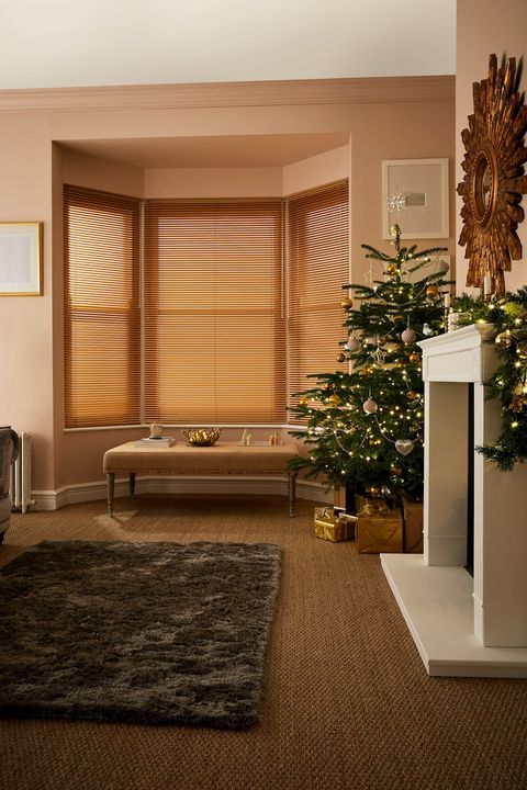 light brown metal venetian blinds on large bay window in cosy christmas living room